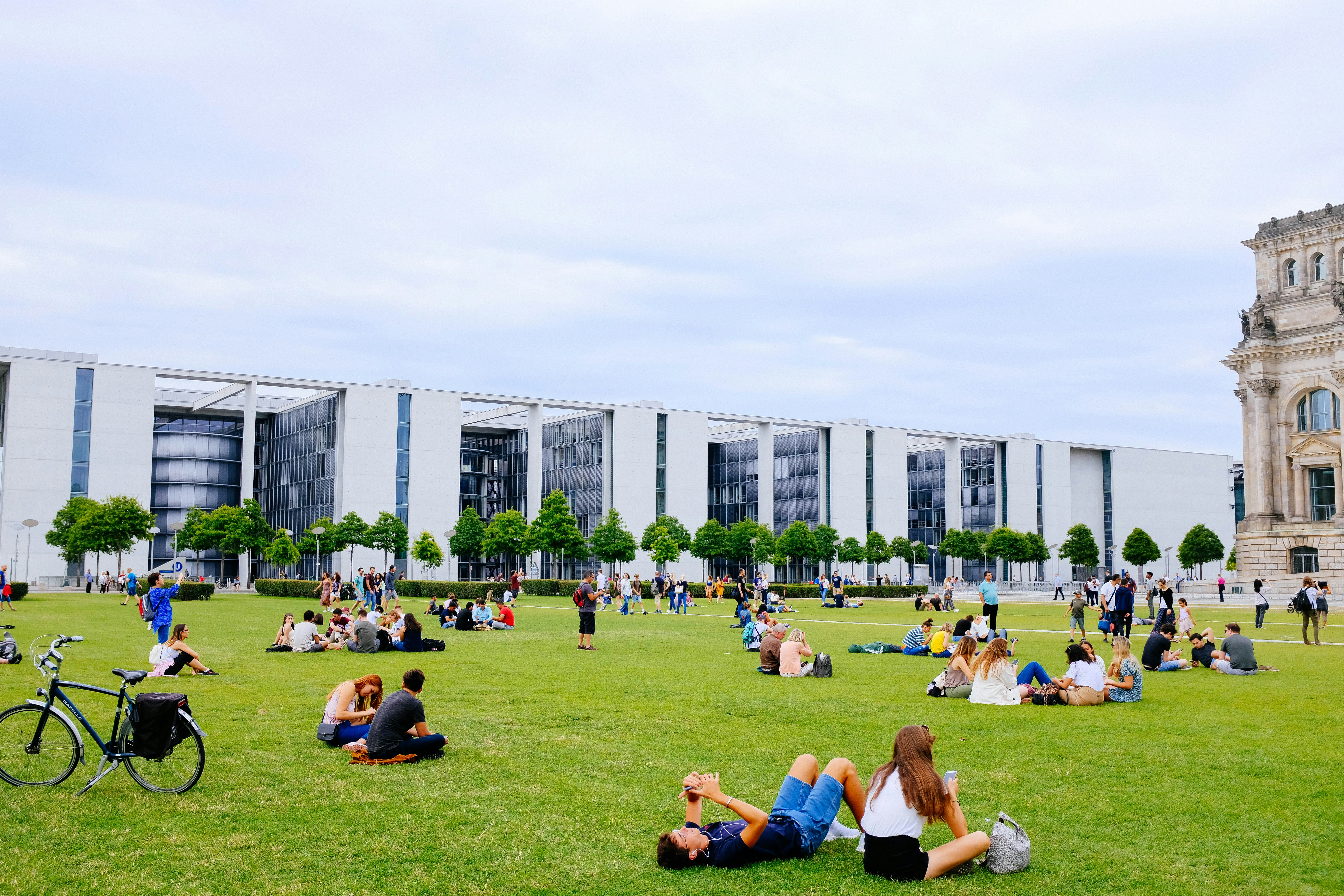 Students sitting together on a green university campus